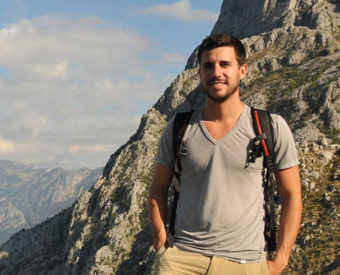 Kotor, ME - Borderless Travels founder Ian Yacobucci cliffside of Europe’s highest fiord