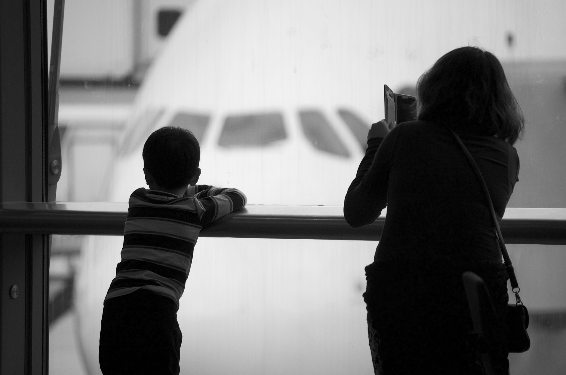 Mom and son checking out an airplane before flying